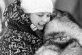Husky dog hugs with beautiful girl. Winter outdoor walking. Black and white. - Reshetiha, Russia - 02.02.2019