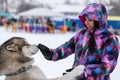 Husky dog hugs with a beautiful girl. Winter outdoor walking - Reshetiha, Russia - 02.02.2019