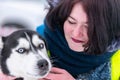 Husky dog hugs with beautiful girl. Winter outdoor walking - Reshetiha, Russia - 02.02.2019