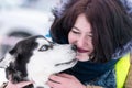Husky dog kissing beautiful girl. Winter outdoor walking - Reshetiha, Russia - 02.02.2019