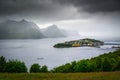 Husoy fishing village on the Senja Island in Norway with in heavy clouds