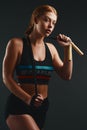 Hustle for the muscle and jump for the rump. Studio portrait of a sporty young woman posing with a skipping rope against Royalty Free Stock Photo