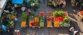 The hustle of an urban market is vivid in this high-angle photo, featuring people amidst stalls of colorful fruits and Royalty Free Stock Photo