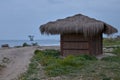 Hut in the beach with a mine tower on background , spring plants and flowers on the floor over the sand in Marbella Royalty Free Stock Photo