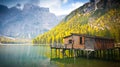 Hut on Braies lake in autumn