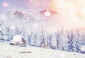 Hut in the mountains in winter, background with some soft highlights and snow flakes. Carpathians, Ukraine. Royalty Free Stock Photo