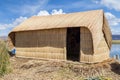 Hut at Uros floating island and village on Lake Titicaca near Puno, Peru Royalty Free Stock Photo