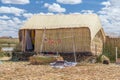 Hut at Uros floating island and village on Lake Titicaca near Puno, Peru Royalty Free Stock Photo