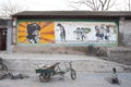 Hutong wall mural featuring Chinese communist hero Lei Feng in a residential street in Beijing