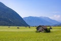 huts for storing materials and hay on a green meadow in the austrian alps Royalty Free Stock Photo