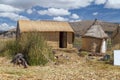 Huts at Uros floating island and village on Lake Titicaca near Puno, Peru Royalty Free Stock Photo