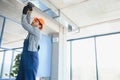 hvac indian worker install ducted pipe system for ventilation and air conditioning. copy space Royalty Free Stock Photo