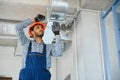 hvac indian worker install ducted pipe system for ventilation and air conditioning. copy space Royalty Free Stock Photo