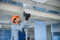 hvac indian worker install ducted pipe system for ventilation and air conditioning. copy space Royalty Free Stock Photo