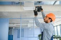 hvac indian worker install ducted pipe system for ventilation and air conditioning. copy space Royalty Free Stock Photo