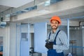 hvac indian worker install ducted pipe system for ventilation and air conditioning. copy space Royalty Free Stock Photo