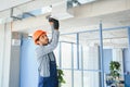 hvac indian worker install ducted pipe system for ventilation and air conditioning. copy space Royalty Free Stock Photo