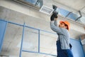 hvac indian worker install ducted pipe system for ventilation and air conditioning. copy space Royalty Free Stock Photo