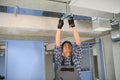 hvac indian worker install ducted pipe system for ventilation and air conditioning. copy space Royalty Free Stock Photo