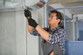 hvac indian worker install ducted pipe system for ventilation and air conditioning. copy space Royalty Free Stock Photo