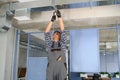 hvac indian worker install ducted pipe system for ventilation and air conditioning. copy space Royalty Free Stock Photo