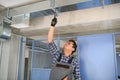 hvac indian worker install ducted pipe system for ventilation and air conditioning. copy space Royalty Free Stock Photo