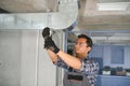 hvac indian worker install ducted pipe system for ventilation and air conditioning. copy space Royalty Free Stock Photo