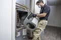 Hvac repairman installing a motor on a heat pump Royalty Free Stock Photo