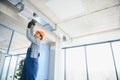 hvac services - indian worker install ducted pipe system for ventilation and air conditioning in house Royalty Free Stock Photo