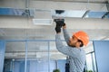 hvac services - indian worker install ducted pipe system for ventilation and air conditioning in house Royalty Free Stock Photo