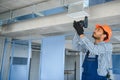 hvac services - indian worker install ducted pipe system for ventilation and air conditioning in house Royalty Free Stock Photo