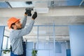 hvac services - indian worker install ducted pipe system for ventilation and air conditioning in house Royalty Free Stock Photo