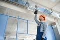 hvac services - indian worker install ducted pipe system for ventilation and air conditioning in house Royalty Free Stock Photo