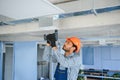 hvac services - indian worker install ducted pipe system for ventilation and air conditioning in house Royalty Free Stock Photo