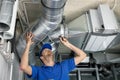 Hvac services - worker install ducted pipe system for ventilation and air conditioning Royalty Free Stock Photo