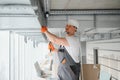 hvac services - worker install ducted pipe system for ventilation and air conditioning in office. Royalty Free Stock Photo