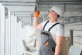 hvac services - worker install ducted pipe system for ventilation and air conditioning in office. Royalty Free Stock Photo