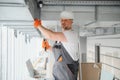 hvac services - worker install ducted pipe system for ventilation and air conditioning in office. Royalty Free Stock Photo