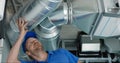 Hvac services - worker install ducted system for ventilation and air conditioning with recuperation