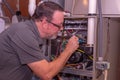 HVAC Technician Adjusting A Gas Furnace