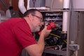 HVAC Tech Inspecting A Gas Furnace