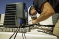 HVAC technician brazing on a condenser Royalty Free Stock Photo