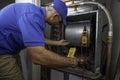 Hvac Technician Checking for Refrigerant Leaks on a Heat Pump