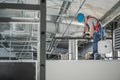 HVAC Technician Finishing System Assembly Inside Commercial Building Warehouse