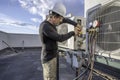 HVAC technician hooking up amp clamp Royalty Free Stock Photo