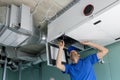 Hvac technician install ducted heat recovery ventilation system with recuperation Royalty Free Stock Photo