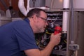 HVAC Technician Looking Over A Gas Furnace Royalty Free Stock Photo