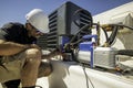 HVAC technician repairing an air conditioner Royalty Free Stock Photo