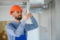 hvac worker install ducted pipe system for ventilation and air conditioning. copy space Royalty Free Stock Photo