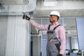 hvac african worker install ducted pipe system for ventilation and air conditioning. copy space Royalty Free Stock Photo